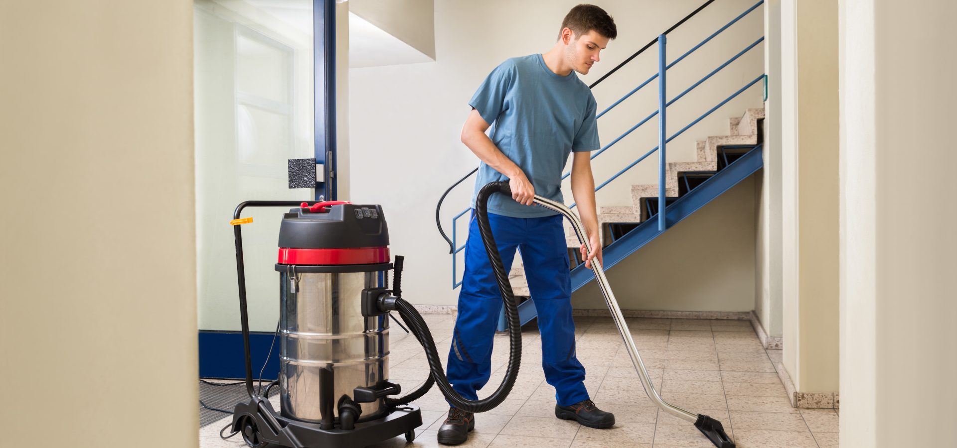CLEANING Man working with large Vacuum Cleaner