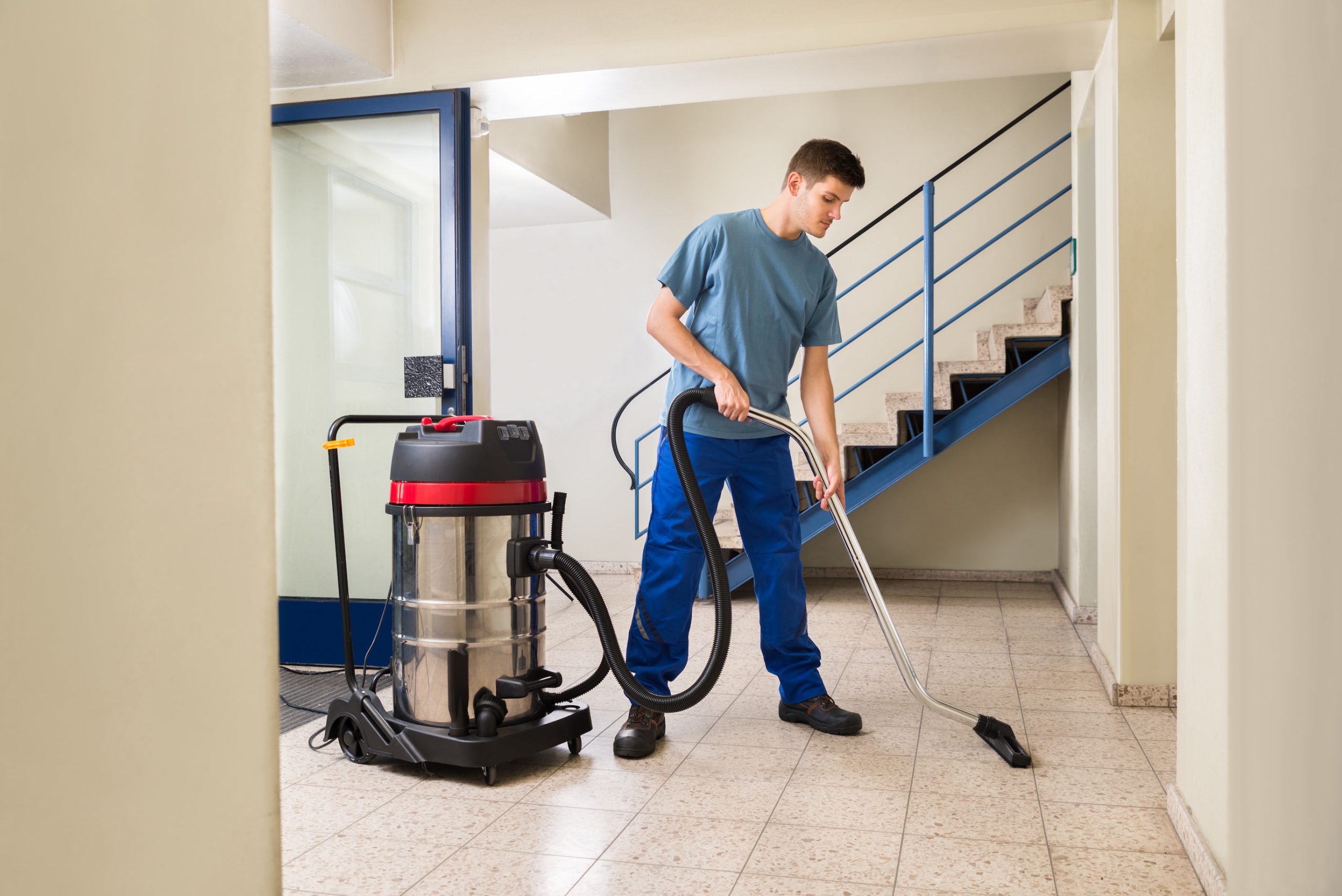 CLEANING Man working with large Vacuum Cleaner